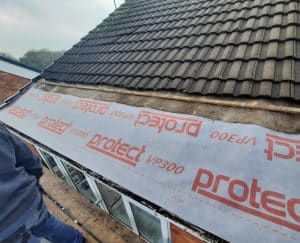 Leaking Felt Roof Repair in progress with a section of tiles removed, showing 'Protect VP300' underlay installed for added protection. PK Roofing and Building ensures durable and professional roofing solutions.
